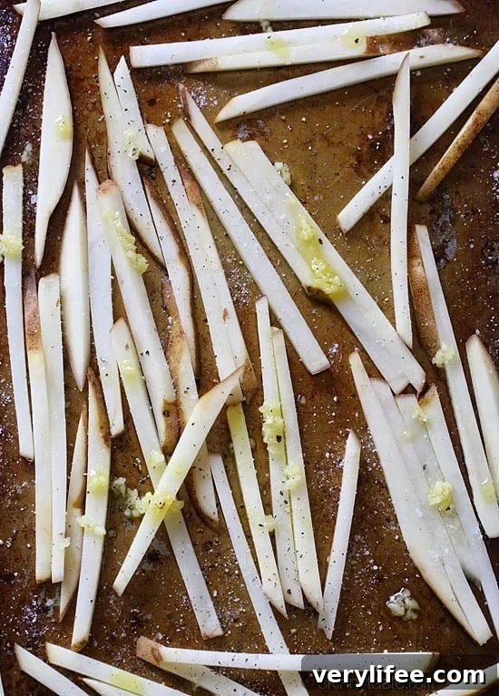 These delicious fries are baked in the oven with garlic and finished with Parmesan and parsley