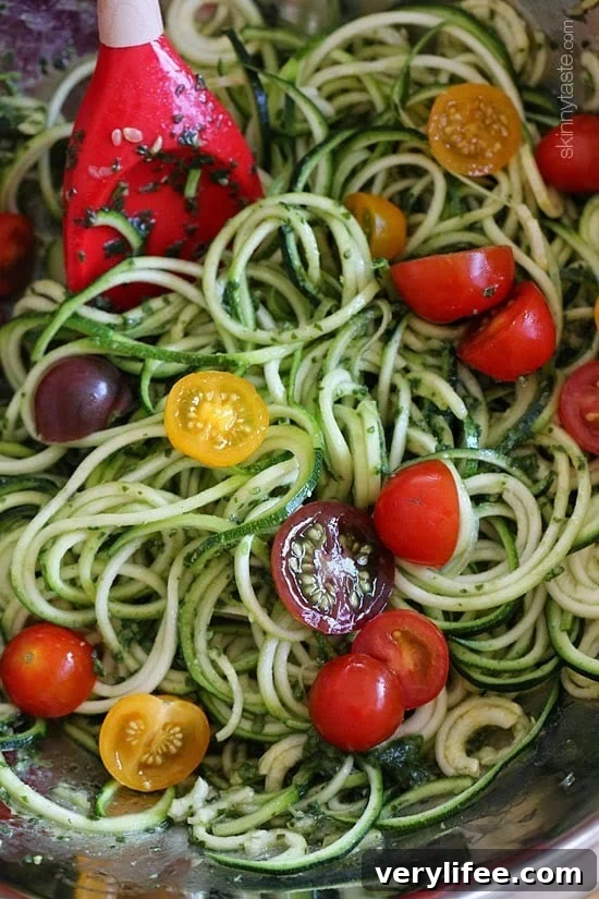 Close up of zoodles with pesto and tomatoes
