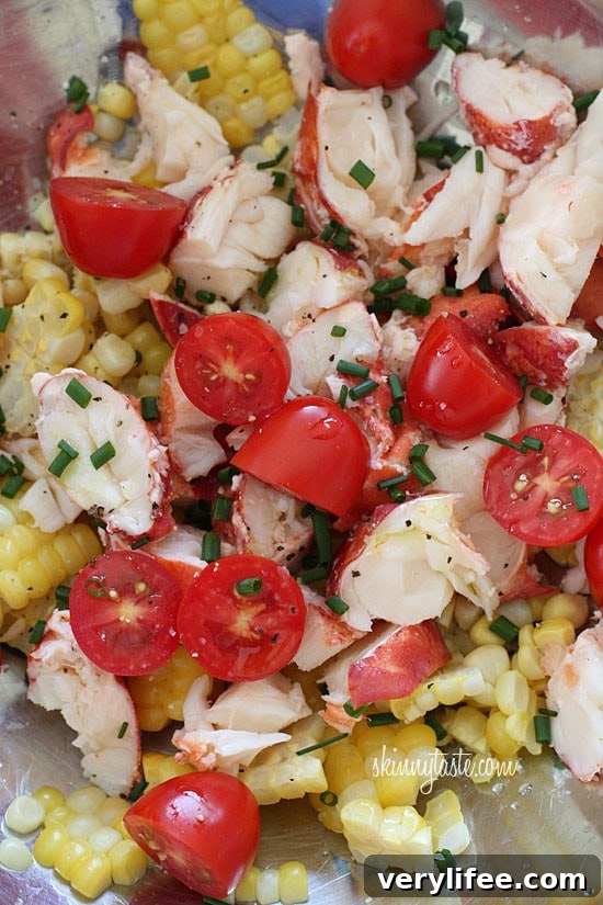 Chilled Lobster Salad with Sweet Summer Corn and Tomatoes, the perfect light summer salad made with sweet summer corn, grape tomatoes, garden herbs and chilled steamed lobster.