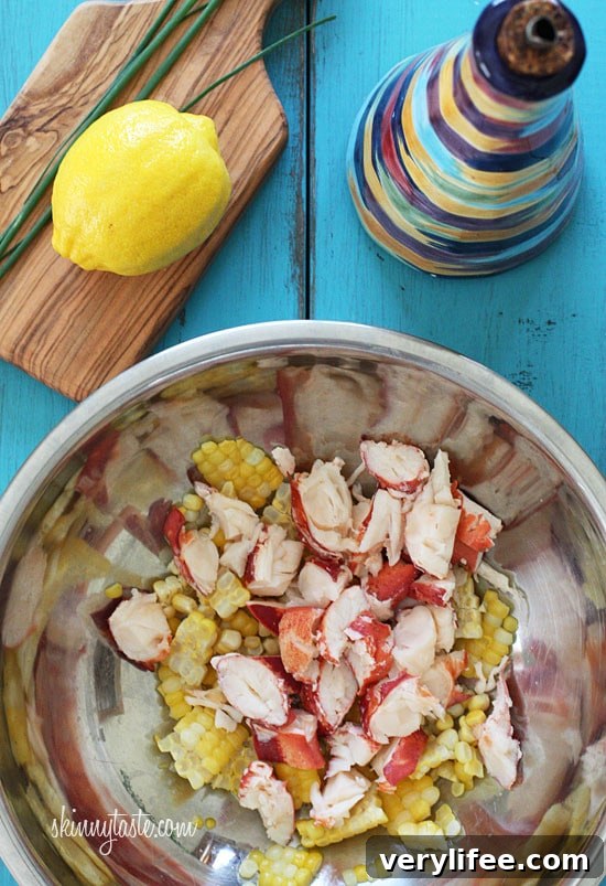 Chilled Lobster Salad with Sweet Summer Corn and Tomatoes, the perfect light summer salad made with sweet summer corn, grape tomatoes, garden herbs and chilled steamed lobster.