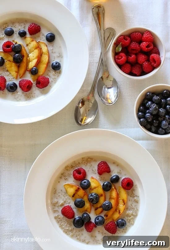 Quinoa cooked in almond milk topped with grilled peaches and berries