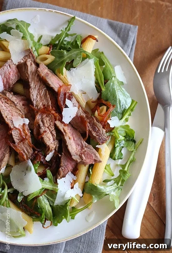 Steak and Pasta Grilled steak, arugula and pasta salad topped with balsamic caramelized onions and shaved Parmesan