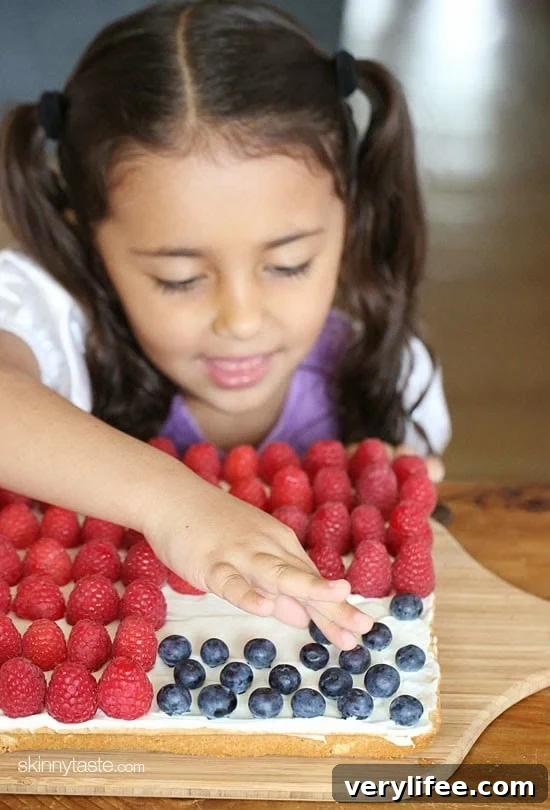 Red, White and Blue fruit "pizza" is more like a cookie bar, topped with cream cheese frosting and fruit.