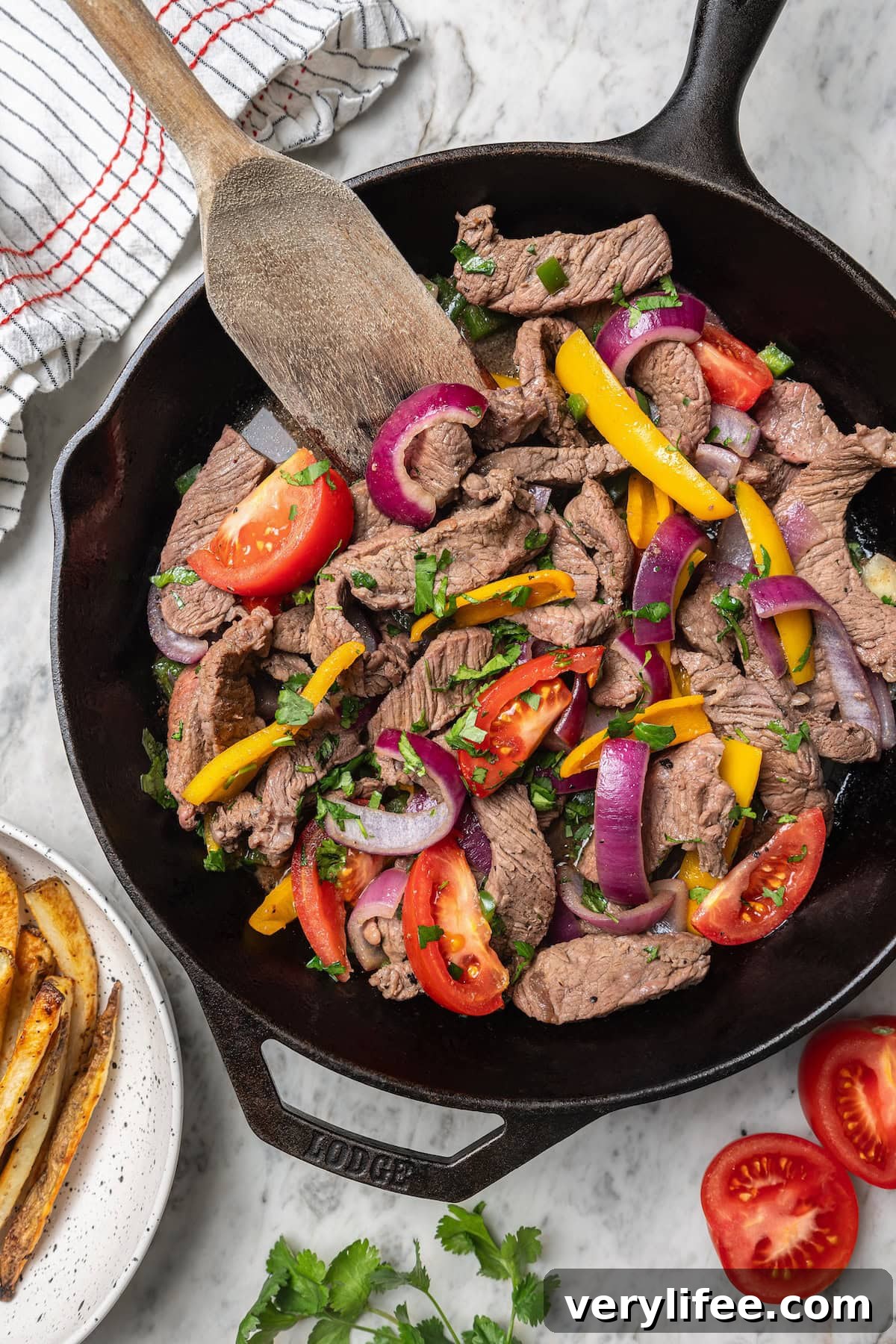 Peruvian Lomo Saltado: Authentic Stir-Fried Beef and Fries 10 Overhead view of lomo saltado cooking in skillet