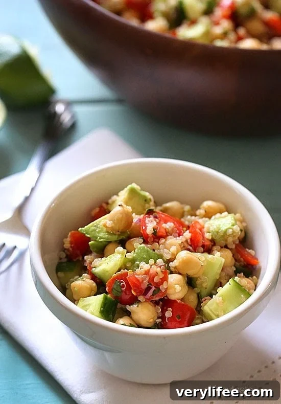 Quinoa chickpea and avocado salad with cucumbers, tomatoes, red onion, lime juice and cilantro – a flavorful vegetarian salad loaded with protein, fiber and healthy fats.