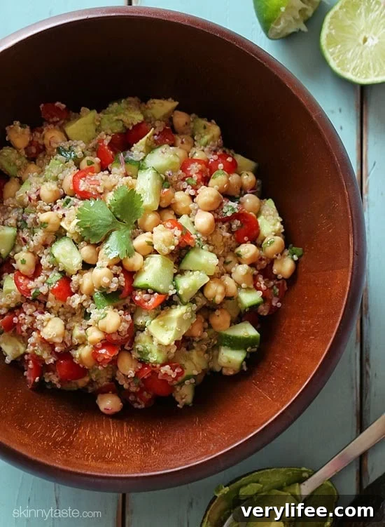 Quinoa chickpea and avocado salad with cucumbers, tomatoes, red onion, lime juice and cilantro – a flavorful vegetarian salad loaded with protein, fiber and healthy fats.