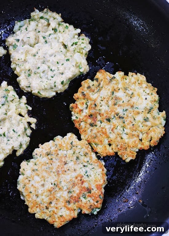 Finished cauliflower fritters with a garnish of parsley