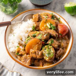 Slow Cooker Latin Beef Stew (Carne Guisada) 9 Carne guisada in a bowl with white rice.