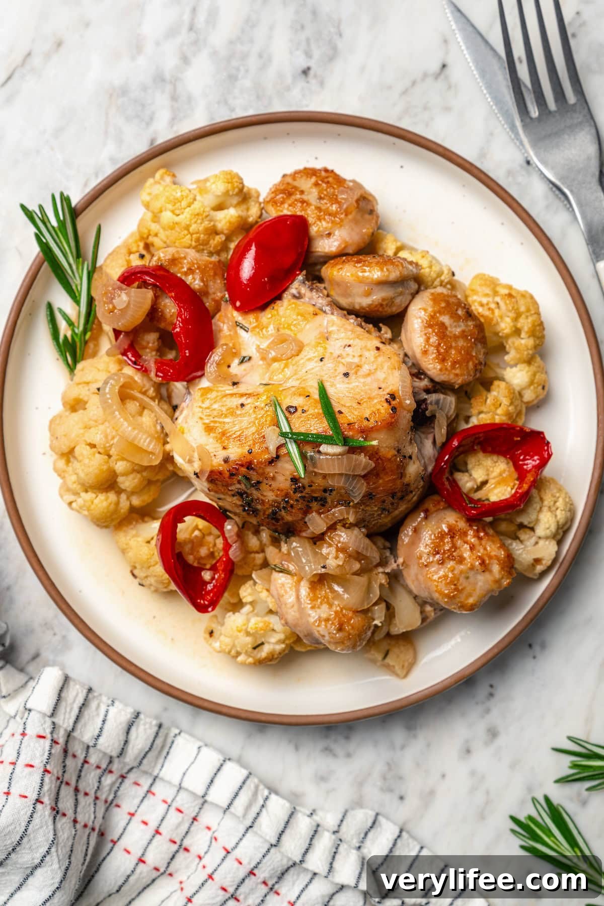 Low-Carb Chicken Scarpariello Recipe 8 Plate of chicken scarpariello with sausage, peppers, and cauliflower.