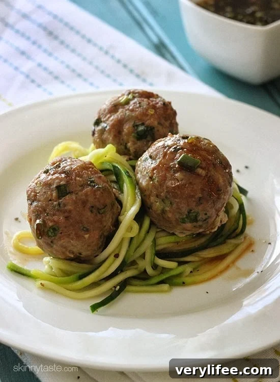 Asian turkey meatballs plated over zucchini noodles