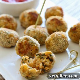 These mini baked Italian rice balls are made with brown rice, chicken sausage, spinach and mozzarella cheese. Served with some warm marinara sauce, they make the perfect finger foods for the Holiday season or any time you want to serve appetizers.