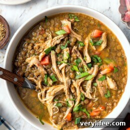 Hearty Chicken and Lentil Soup Recipe 5 Bowl of chicken lentil soup with cilantro.