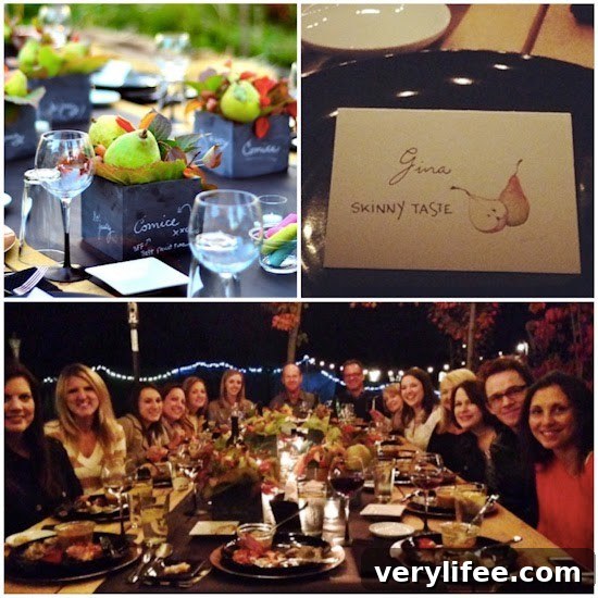 Broiled Wild Salmon with Cherry-Apple Chutney Recipe 3 A tabletop with decorative boxes with pears and wine glasses, a name card for Gina from SkinnyTaste with a picture of pears, a group of 14 people around a large dinner table with plates of food and beverages