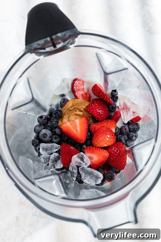 berries and peanut butter in a blender