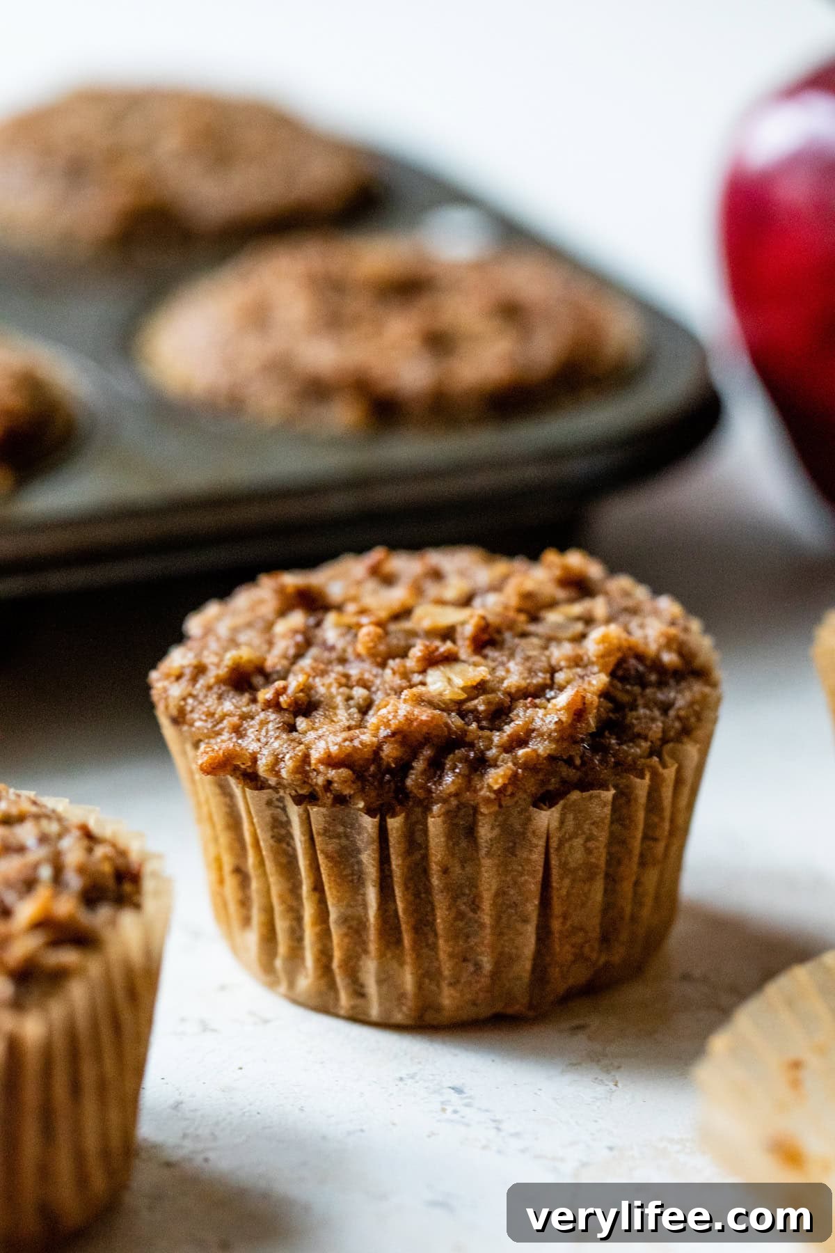 Homemade Apple Cinnamon Muffins Recipe 8 Healthy Apple Muffins on a counter.