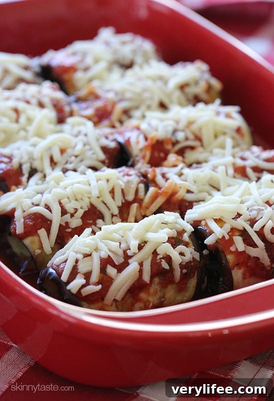 Unbaked eggplant rollatini in a baking dish.