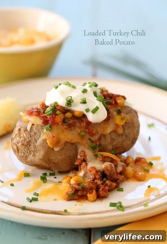 Loaded turkey chili baked potato topped with cheese and chives