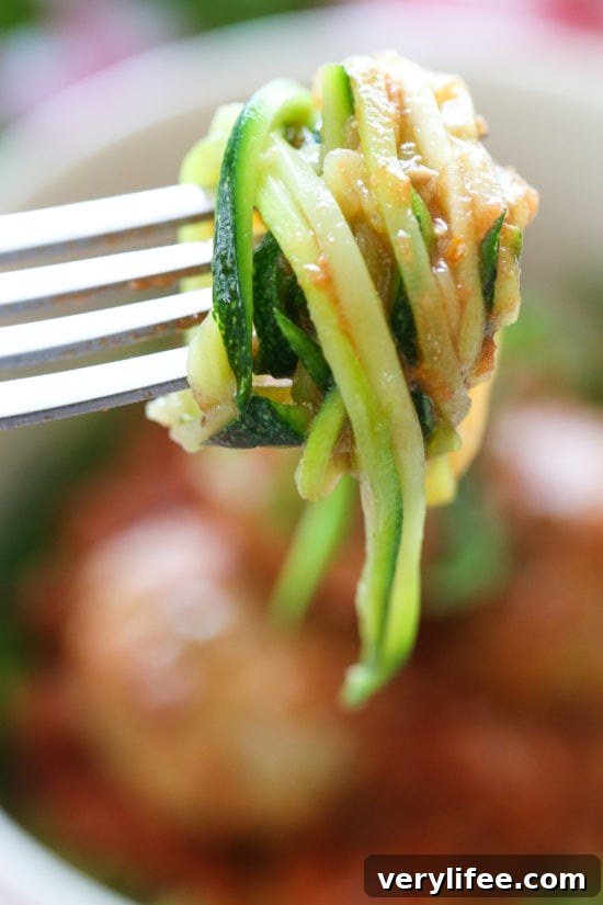 Zoodles with Slow Cooker Turkey Meatballs 4 Serving of zucchini noodles topped with meatballs and sauce.