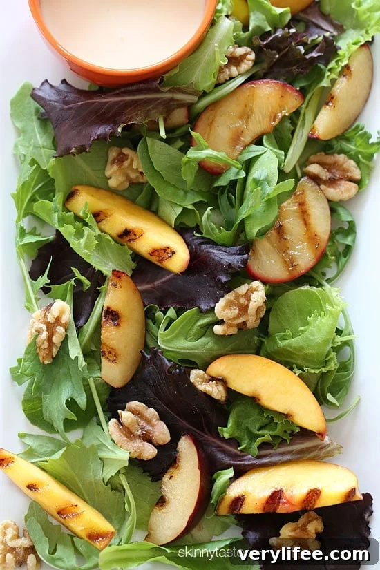 Grilled stone fruit like peaches and plums served over baby greens with walnuts and a sweet honey goat cheese dressing, this salad is light and delicious!