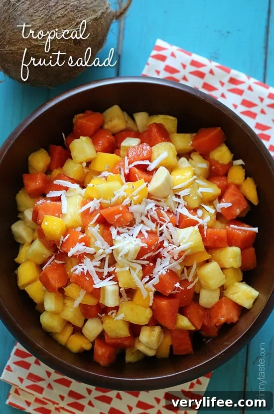 This tropical fruit salad, made with fresh papaya, mango, pineapple, bananas and grated coconut is the best tasting fruit salad... EVER!!