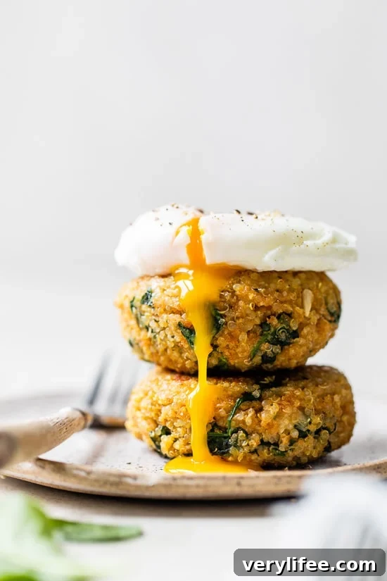Crispy Spinach and Quinoa Patties 2 Quinoa and Spinach Patties with a poached egg on top.