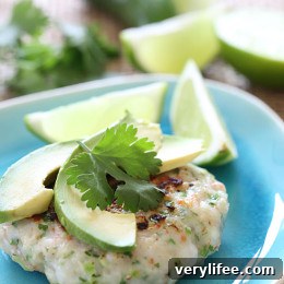 Crispy Jalapeño Shrimp Cakes with Lime Aioli 3 Shrimp cakes on a plate with avocado and lime