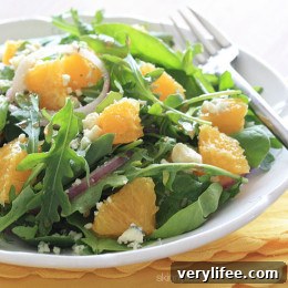 Orange and arugula salad with red onion and Gorgonzola on a plate