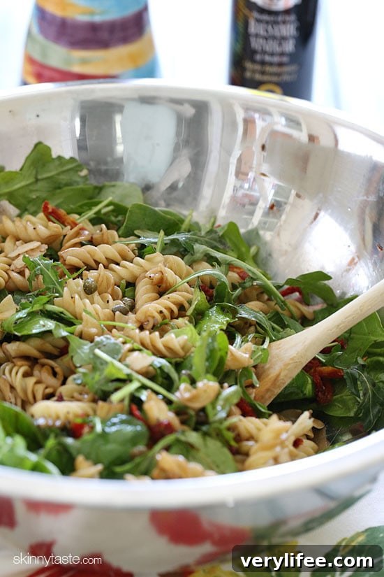 Refreshing Summer Pasta Salad with Baby Greens 3 Summer pasta salad with arugula, spinach, sun dried tomatoes, capers and shaved Parmesan