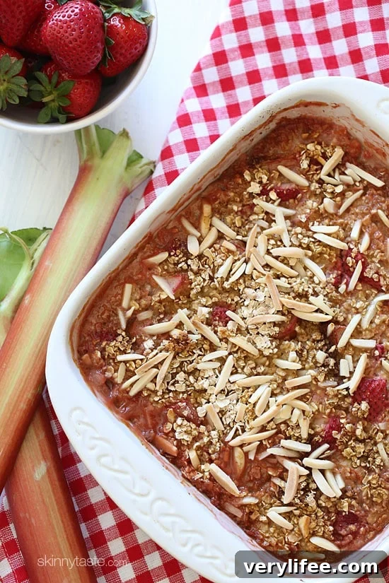 Baked oatmeal with strawberries and rhubarb topped with slivered almonds