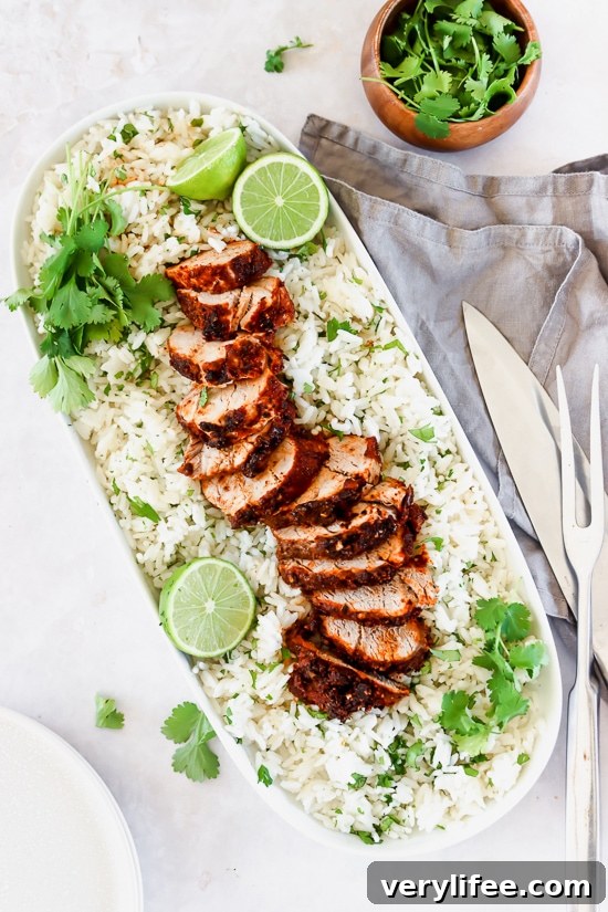 Mexican Adobo Pork Tenderloin with rice on a platter