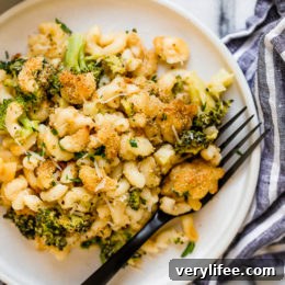 Creamy Broccoli Mac and Cheese Recipe 4 Plate of broccoli mac and cheese with fork.
