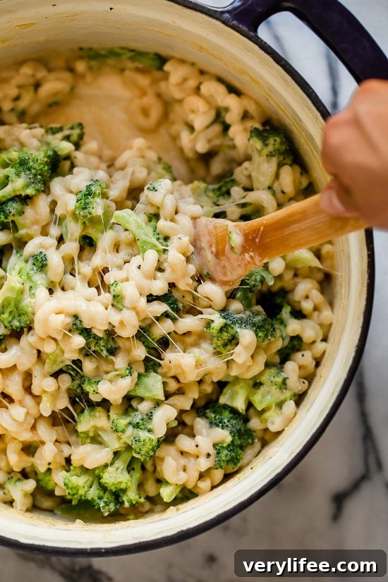 Creamy Broccoli Mac and Cheese Recipe 6 Stirring broccoli macaroni and cheese in Dutch oven.