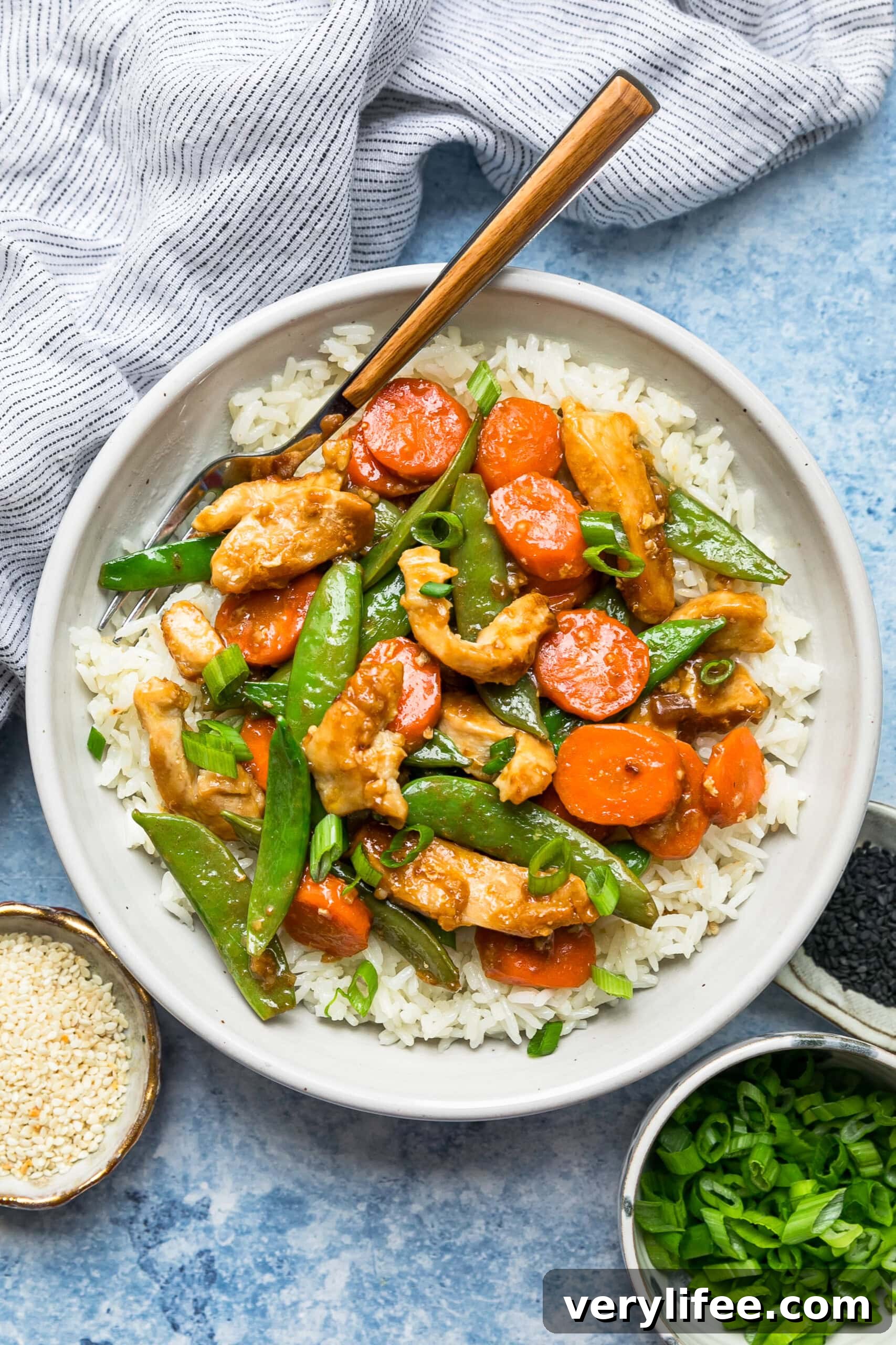 Quick Chicken and Vegetable Stir Fry Recipe 8 Overhead view of chicken and vegetable stir fry served over a bowl of rice.