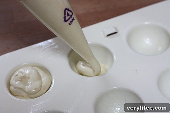Piping the batter into the cake pop mold.