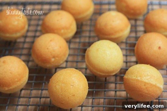 Cooling the baked cake balls on a rack.