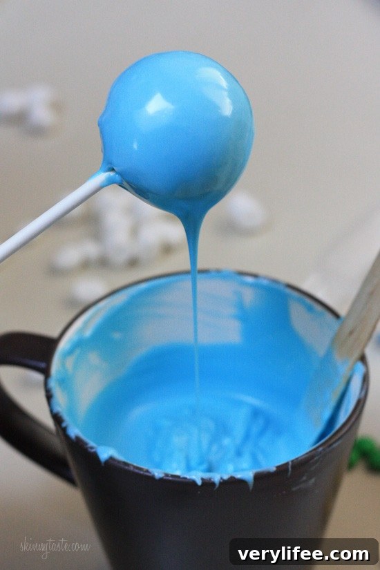 Dipping the cake pops into melted chocolate.