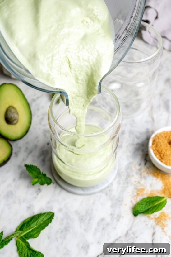 Pouring shamrock shake into glass