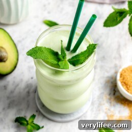 Shamrock shake copycat recipe in glass with sprig of fresh mint
