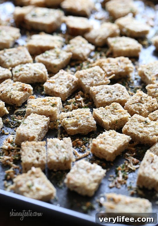 Healthier homemade croutons made with whole grain bread, Italian seasoning and shredded parmesan cheese.