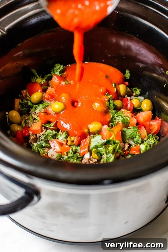 Slow Cooker Picadillo Recipe with Ground Beef 4 Crock Pot Picadillo is a flavorful Cuban dish made with ground beef and a sauce made from simmering tomatoes, green olives, bell peppers, cumin, and spices.