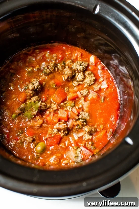 Slow Cooker Picadillo Recipe with Ground Beef 5 Crock Pot Picadillo is a flavorful Cuban dish made with ground beef and a sauce made from simmering tomatoes, green olives, bell peppers, cumin, and spices.