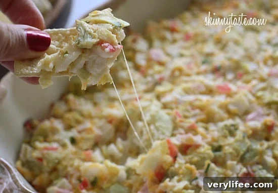 Hot and cheesy imitation crab and artichoke dip is to die for! Serve this glorious dip with baked chips and you will have the perfect appetizer for any party.