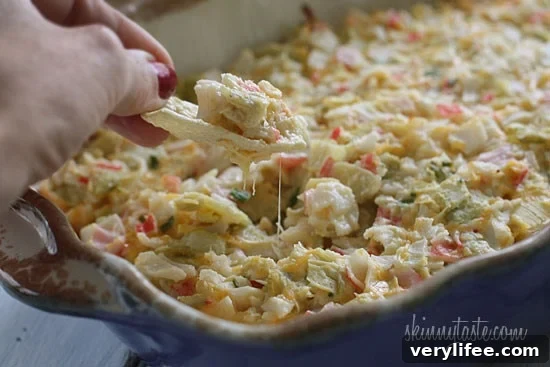 Creamy Baked Crab and Artichoke Dip 4 Hot and cheesy imitation crab and artichoke dip is to die for! Serve this glorious dip with baked chips and you will have the perfect appetizer for any party.