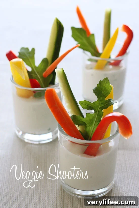 Veggie shooters with fresh cut vegetables in shot glasses and a light ranch dip