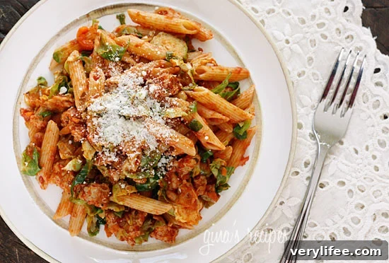 Penne pasta tossed with sautéed Brussels sprouts and a light meat ragu made from ground turkey and a bit of Italian pork sausage — a hearty Autumn pasta dish.