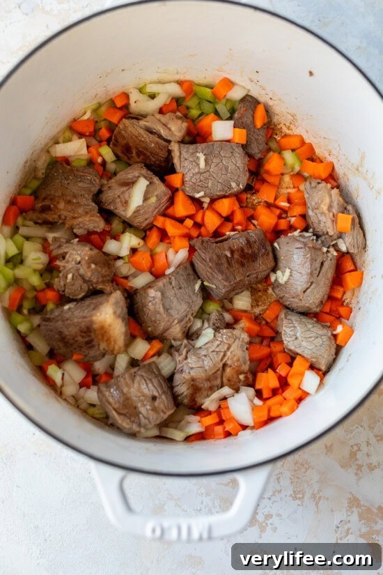 Hearty Beef and Barley Soup Recipe 7 beef and vegetables in a pot