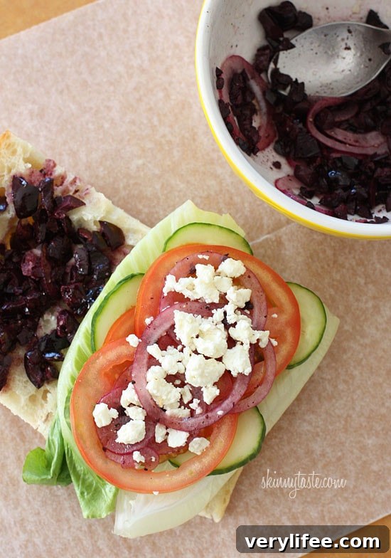Greek Salad Sandwich Recipe with Feta and Kalamata Olives 3 If you love a Greek Salad, then you'll love this sandwich. Crisp Romaine lettuce, tomatoes, cucumbers, kalamata olives, feta cheese and red onion on ciabatta bread with a touch of oil and red wine vinegar.