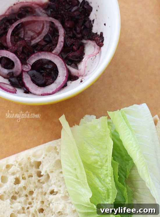 Greek Salad Sandwich Recipe with Feta and Kalamata Olives 5 If you love a Greek Salad, then you'll love this sandwich. Crisp Romaine lettuce, tomatoes, cucumbers, kalamata olives, feta cheese and red onion on ciabatta bread with a touch of oil and red wine vinegar.