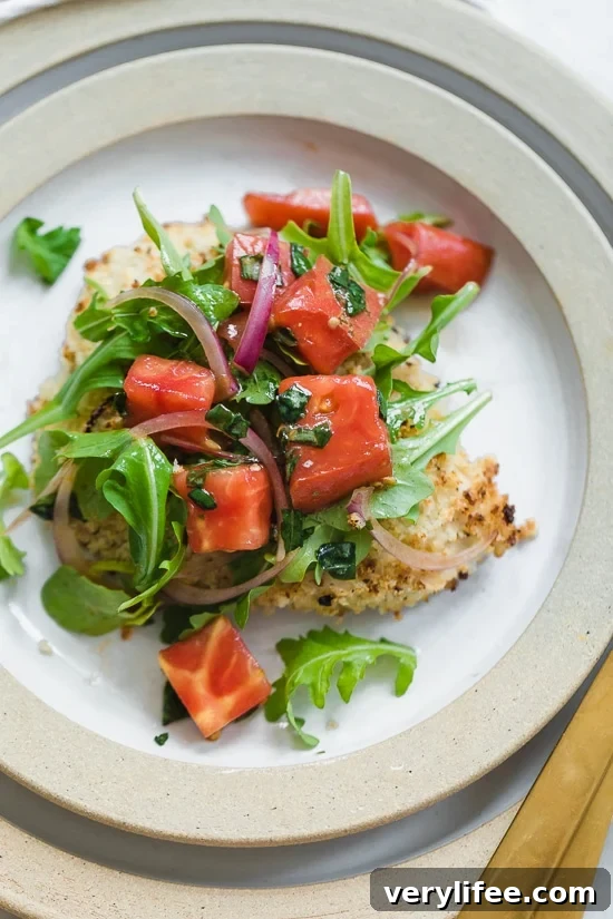Baked Chicken Milanese is made with breaded chicken cutlets, baked in the oven topped with arugula, tomatoes and balsamic. This is my favorite restaurant dish, made healthier!