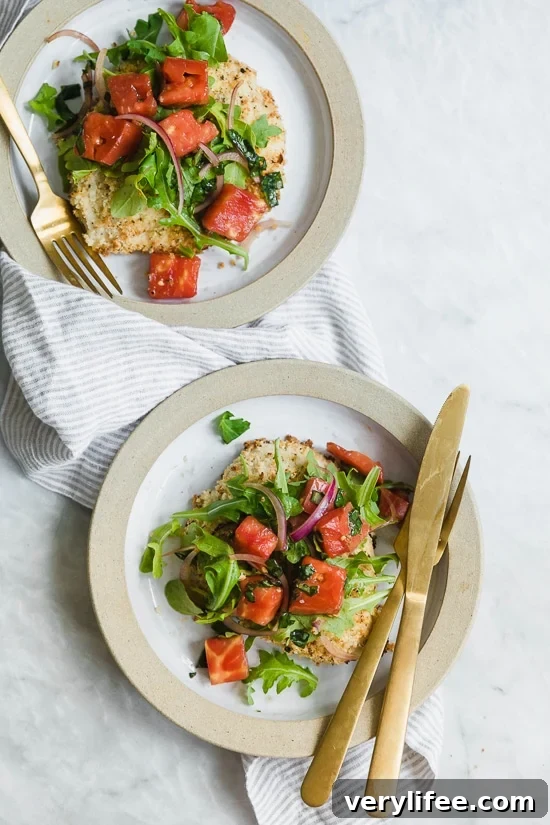Baked Chicken Milanese is made with breaded chicken cutlets, baked in the oven topped with arugula, tomatoes and balsamic. This is my favorite restaurant dish, made healthier!